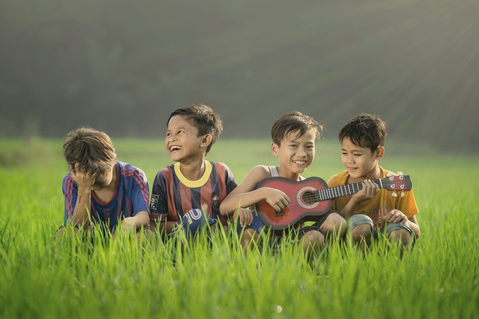 Children sitting together in long grass