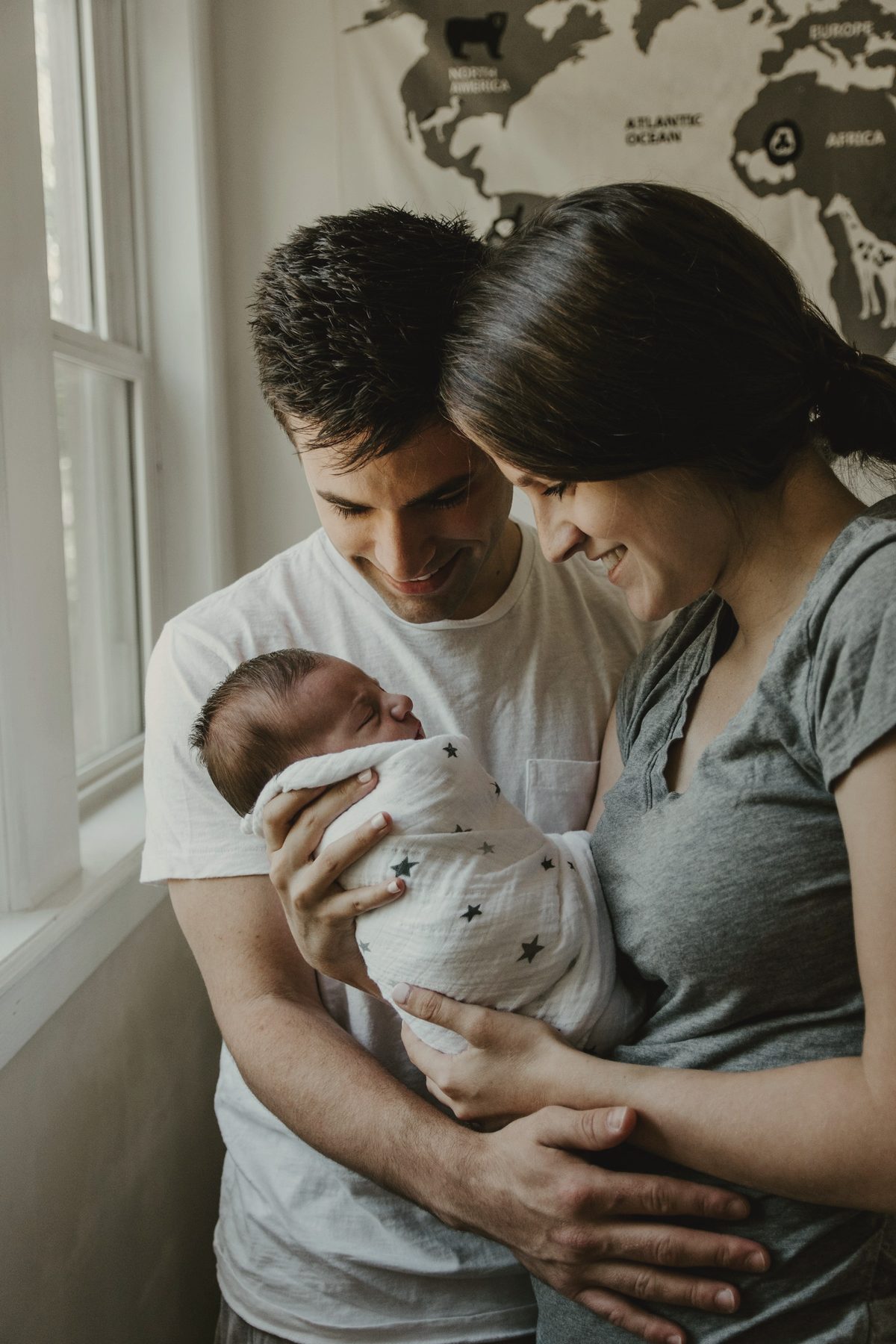 Two parents holding a newborn between them